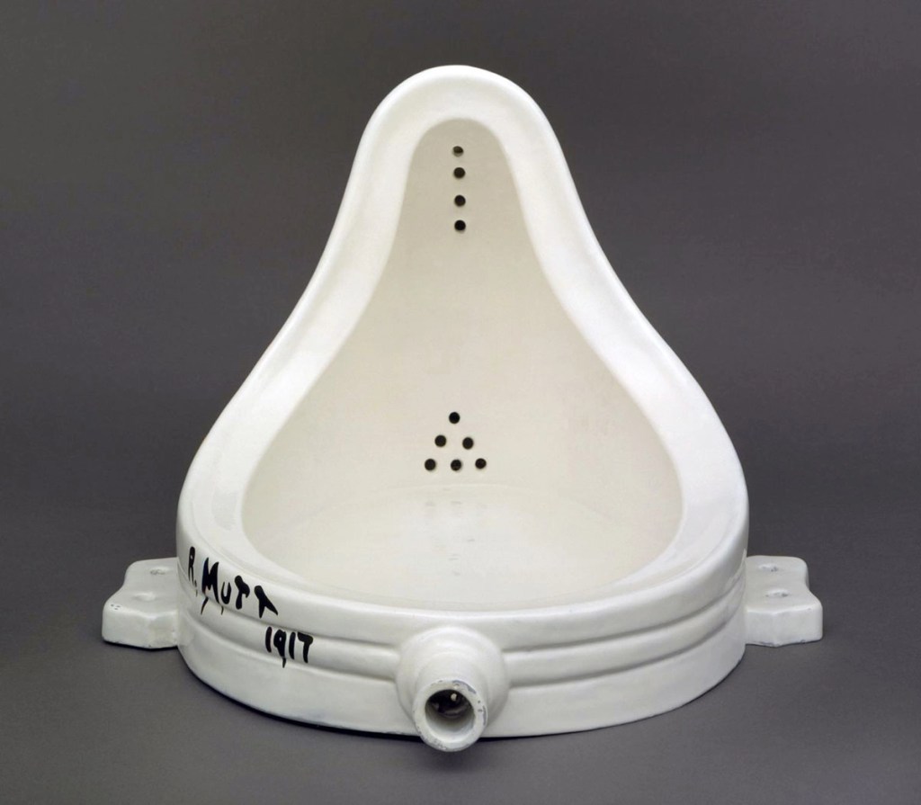 A white ceramic urinal, titled 'Fountain', with a distinct design and signed 'R. Mutt 1917'.